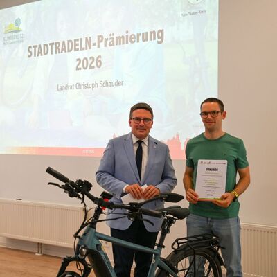Das Bild zeigt Stadtradeln-Star Nils Hofmann (r.) aus Igersheim gemeinsam mit Landrat Christoph Schauder: Er verzichtete in den 21 Tagen g�nzlich auf das Auto und legte in den drei autofreien Wochen insgesamt 374 Kilometer zur�ck.
